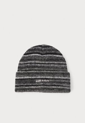 Knitted beanie in gray and black stripes with a folded cuff. Features "URTRA" logo in silver stitching on the cuff. Soft, textured material.