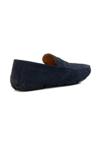 Navy suede loafers with a low profile, rounded toe, and a textured black rubber sole. Features visible stitching and a comfortable slip-on design.