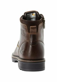 Braune Leder-Stiefelette mit rauem Kragen, Reißverschluss und Gummisohle mit horizontalen Rillen für guten Halt. Präge-Logo-Detail.
