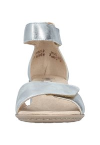 Silver metallic ankle strap sandal with a wide front band and a cushioned sole. Features a minimalistic design and soft texture.