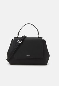Black handbag made of smooth synthetic material, featuring a structured shape, a top handle, and an adjustable shoulder strap. Silver logo detail.