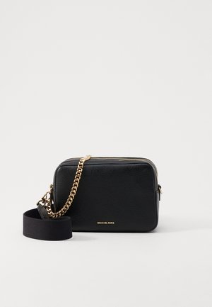 Black leather crossbody bag with gold chain accents, zipper closure, and a detachable fabric strap. Michael Kors logo on the front.