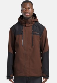 Wasserdichte Jacke mit einem braun-schwarzen Farbblockdesign, hohem Kragen, verstellbare Kapuze und Reißverschlusstaschen.