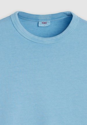 Light blue cotton t-shirt with a crew neck, ribbed collar, and a smooth texture. Tag visible at the back, labeled size S.