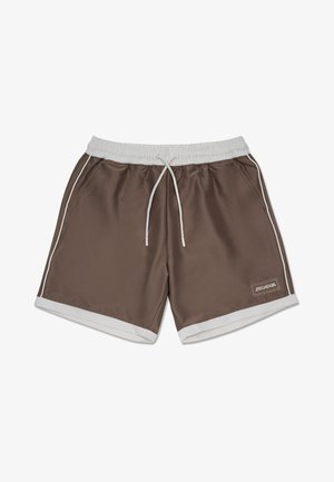 Bañador marrón con cordón blanco y detalles en blanco. Presenta bolsillos laterales y un dobladillo blanco. Incluye un pequeño parche de marca.