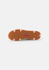 Suela de zapato con una superficie de goma naranja texturizada, que presenta un patrón de cuadrados y un acento de logo central en rojo. Diseño antideslizante.