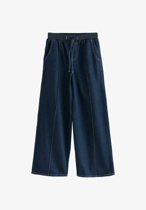 Široké tmavé džínsy s elastickým pásom, sťahovacou šnúrkou a prednými vreckami. Má kontrastné šitie pozdĺž švov.