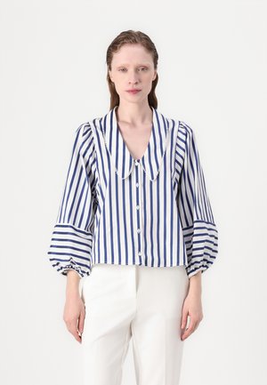Striped blouse featuring blue and white vertical stripes, a large collar with a trim, and puffy sleeves with elastic cuffs. Buttons are centered.