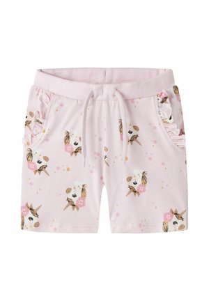 Shorts pour enfants rose clair avec des visages de licornes, des fleurs roses, une taille à cordon et des bords de poche froncés des deux côtés.