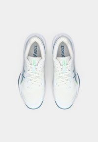 White athletic shoes with a mesh upper, featuring blue accents and textured details. Laces are white, with a green logo on the tongue.