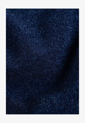 Navy blue textured fabric with a fine, soft weave, displaying subtle variations in shade and depth. Ideal for clothing or upholstery.