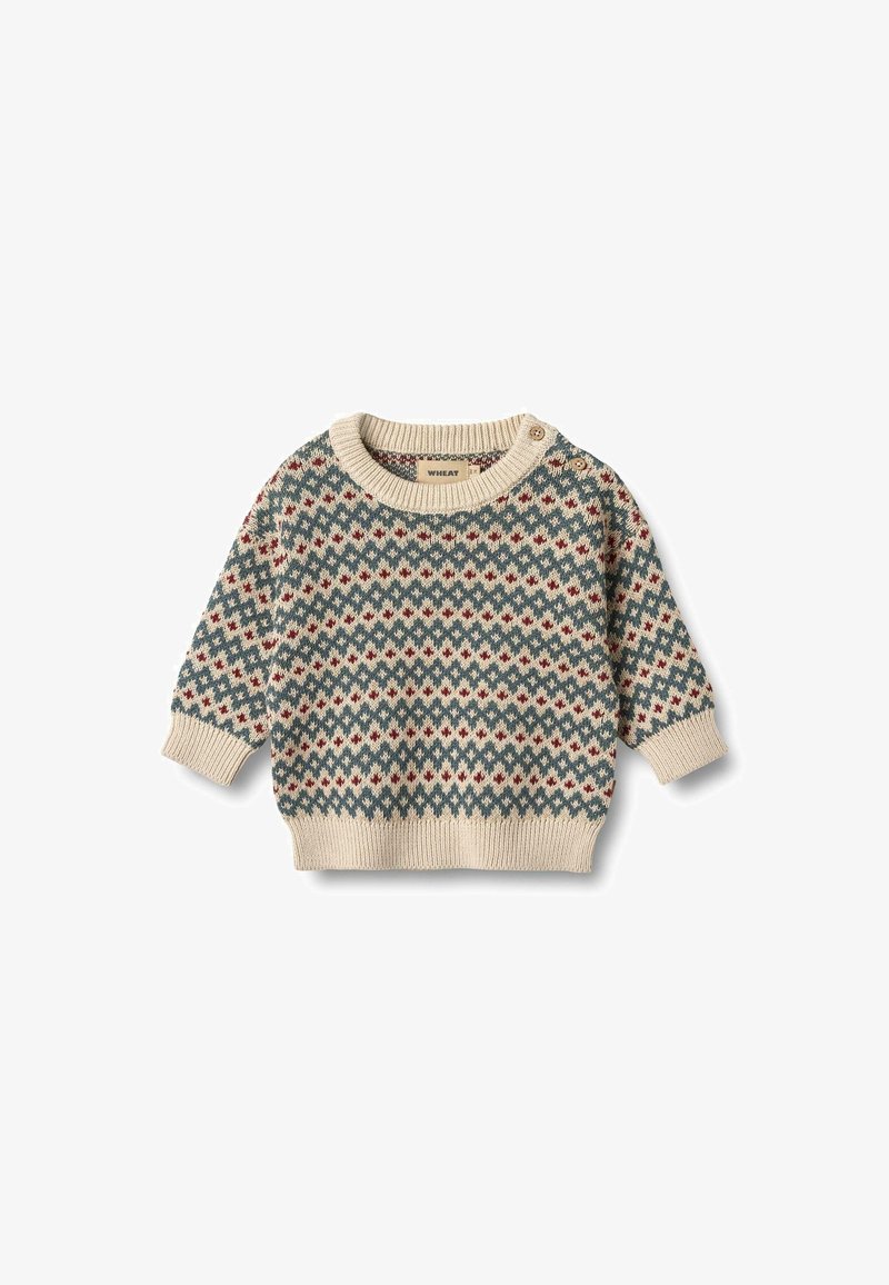 Ljusbeige stickad tröja med rundad hals, med geometriska röda och blå mönster, långa ärmar och knappdetaljer på axeln.