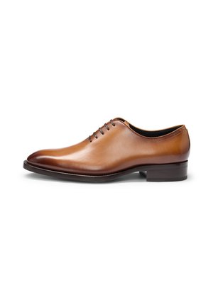 Brown leather dress shoe with a smooth finish, lace-up design, and rounded toe. Features a low heel and minimalistic stitching details.
