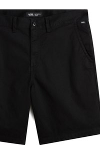 Shorts chino noirs Vans avec poches avant, passants pour ceinture et fermeture par bouton à la taille.