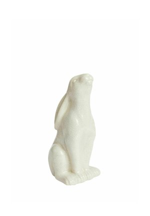 Figura di coniglio in ceramica bianca lucida seduto eretto con orecchie lunghe e superficie dettagliata e strutturata su sfondo bianco.