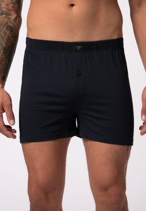 Boxers bleu marine en tissu doux, avec une taille élastique, une fermeture à boutons et une texture lisse.