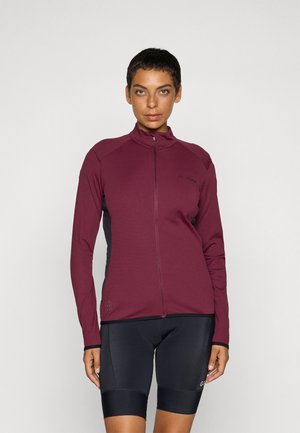 Maroon cycling jacket with high collar, full front zipper, and black side panels. Smooth fabric with logo detail on the chest.