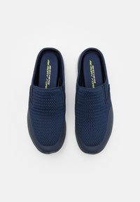 Navy blue slip-on sneakers with breathable mesh upper, memory foam insoles, and rubber outsoles, featuring elastic side gores for ease of wear.
