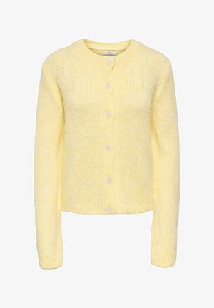 Sárga kötött kardigán kerek nyakkal, hosszú ujjakkal és öt elöl található gombbal. Puha tapintású, finoman pettyezett mintával az egész felületen.