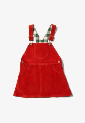 Vestito salopette in velluto a coste rosso con tasca frontale, bottoni in ottone e bretelle regolabili a quadretti verdi e bianchi.