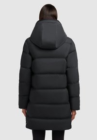 Black puffer coat with a detachable hood, quilted design, long sleeves, and knee-length fit, featuring a smooth texture and minimal detailing.