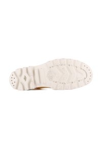 Semelle de chaussure en caoutchouc blanc avec des motifs de grip texturés, dotée d'un logo en relief et de multiples éléments de traction, conçue pour la durabilité et la stabilité.