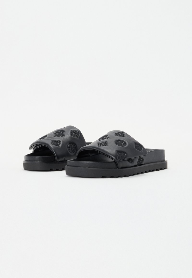 Sandales slides noires avec un motif texturé embossé sur le dessus. Semelle plate avec un dessous strié pour une meilleure traction. Design ouvert au niveau des orteils.