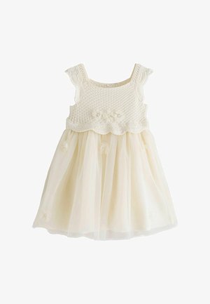 Kremasta dječja haljina s kukičanim korzetom, prozračnim rukavima, cvjetnim aplikacijama i til suknjom.