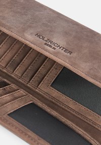 Brown leather wallet with multiple card slots, embossed "HOLZRICHTER BERLIN" logo, and a contrasting black interior texture.