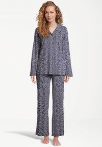 Mörkblå pyjamasset med lång ärm och byxor, pryder av ett vitt prickmönster, tillverkat av mjukt, lätt tyg med en avslappnad passform.