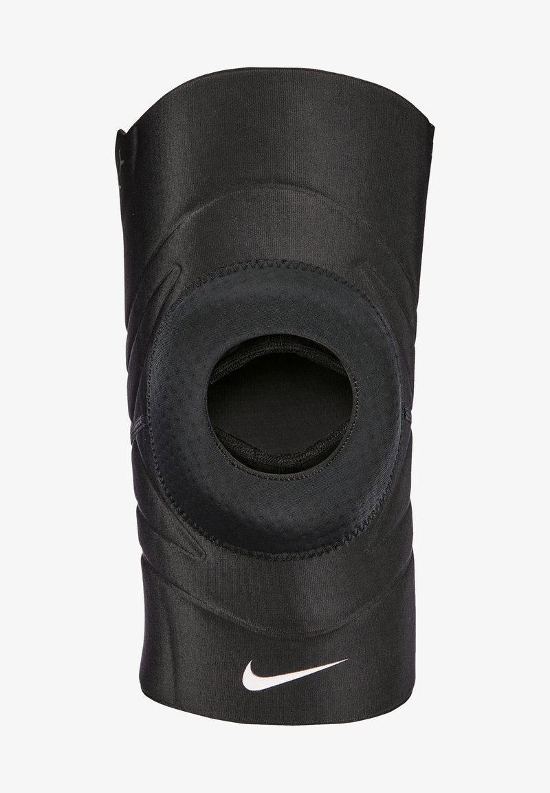 Ginocchiera nera realizzata in tessuto elastico con un'apertura per la patella, dotata di dettagli testurizzati e di un logo Nike bianco.