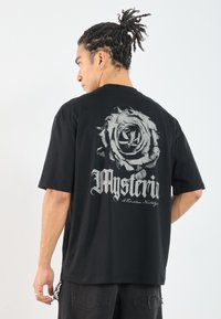 Black cotton t-shirt featuring a large, detailed gray rose graphic on the back with the text "Mysterium" in stylized lettering.