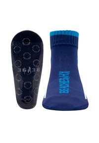 Navy Socken mit strukturiertem Obermaterial, kontrastierenden türkisfarbenen Akzenten und schwarzer Gummisohle mit kreisförmigen Grip-Mustern.