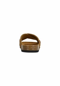 Bruine kurken zoolsandalen met twee gekruiste banden, een textuur oppervlak, en een transparante buitenzool. Zwarte rubberen zool voor grip.