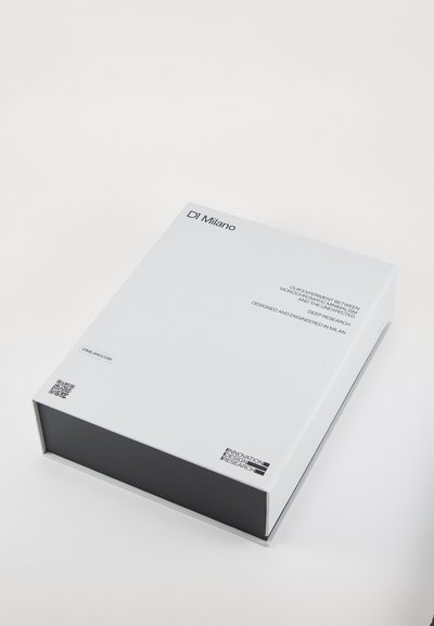 White box packaging with a matte finish, featuring black text and QR codes, showcasing minimalist design and sleek rectangular shape.