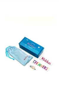Scatola di cartone blu con design a onde, contiene un sacchetto azzurro con coulisse e adesivi colorati: "Kiddus," "DREAM BIG," e "Sei Meraviglioso."