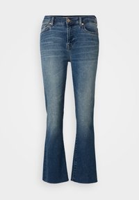 Jeans i denim med utsvängda ben i en medelblå tvättning, med hög midja, femfickorsdesign och subtilt slitningar framtill.