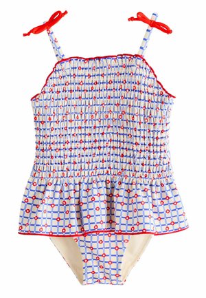 Blå- og hvidternede badedragt med røde detaljer, smocket krop og flæset peplum. Toppen har stropper, der bindes med røde sløjfer ved skuldrene.