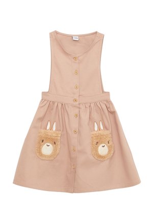 Robe sans manches marron clair avec des boutons sur le devant et deux poches frontales affichant des visages d’ours avec des oreilles sur chaque poche.