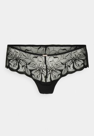 Fio dental preto de renda com bordado floral, design em malha transparente, bordas onduladas, painel frontal em tecido sólido e um detalhe decorativo em tom dourado.