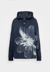 Mörkblå hoodie med en stor ljusblå blommig grafisk design på framsidan. Har en dragsko i huvan och ribbade muddar. Mjuk material och avslappnad passform.