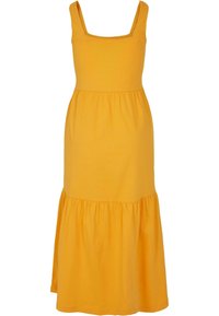 Żółta maxi sukienka z bawełny z kwadratowym dekoltem, dopasowanym korpusem i słupkowym dołem z marszczoną falbaną na końcu.