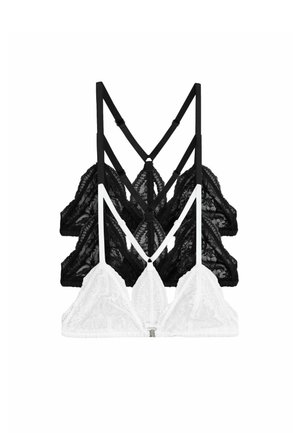 Three lace bralettes stacked, two black in back and one white in front, with thin adjustable straps and triangle cups.
