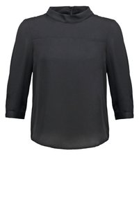 Blouse noire à manches longues, col montant et fermeture éclair dans le dos, avec un ourlet droit et des détails subtils de coutures sur la poitrine.