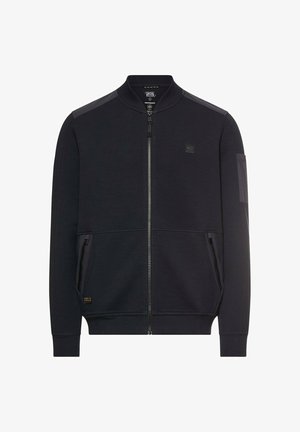 Schwarze Bomberjacke mit Reißverschluss, geripptem Kragen und Bündchen, zwei vorderen Reißverschlusstaschen sowie einem kleinen Patch-Logo auf der Brust und der Ärmeltasche.