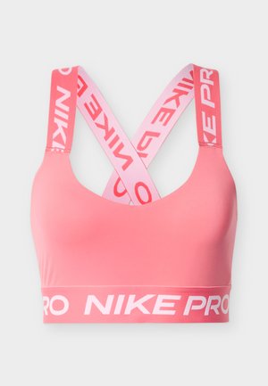 Roosa spordirinnahoidja, millel on sile tekstuur, ristkihtedega rihmad ja lai riba valge "NIKE PRO" logoga.