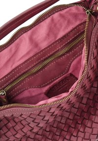 Woven burgundy leather bag interior, featuring a pink lining and a zippered pocket, with gold-tone zipper and stitching details.