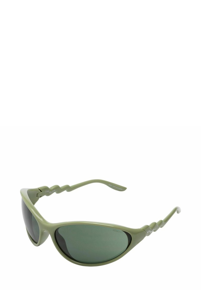 Lunettes de soleil avec une monture en plastique d'un vert olive clair et des verres teintés en vert foncé. Les branches texturées présentent un design ondulé.