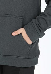 Dark gray hoodie featuring a front pocket, ribbed cuffs, and smooth fabric texture. Snug fit with a casual design, minimal stitching details.