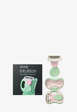 Wilkinson Sword Intuition Complete Care Mini -partahöylä mintunvihreällä ergonomisella kahvalla, vaaleanpunaisella napilla ja vastaavalla kompaktilla matkalaukulla.